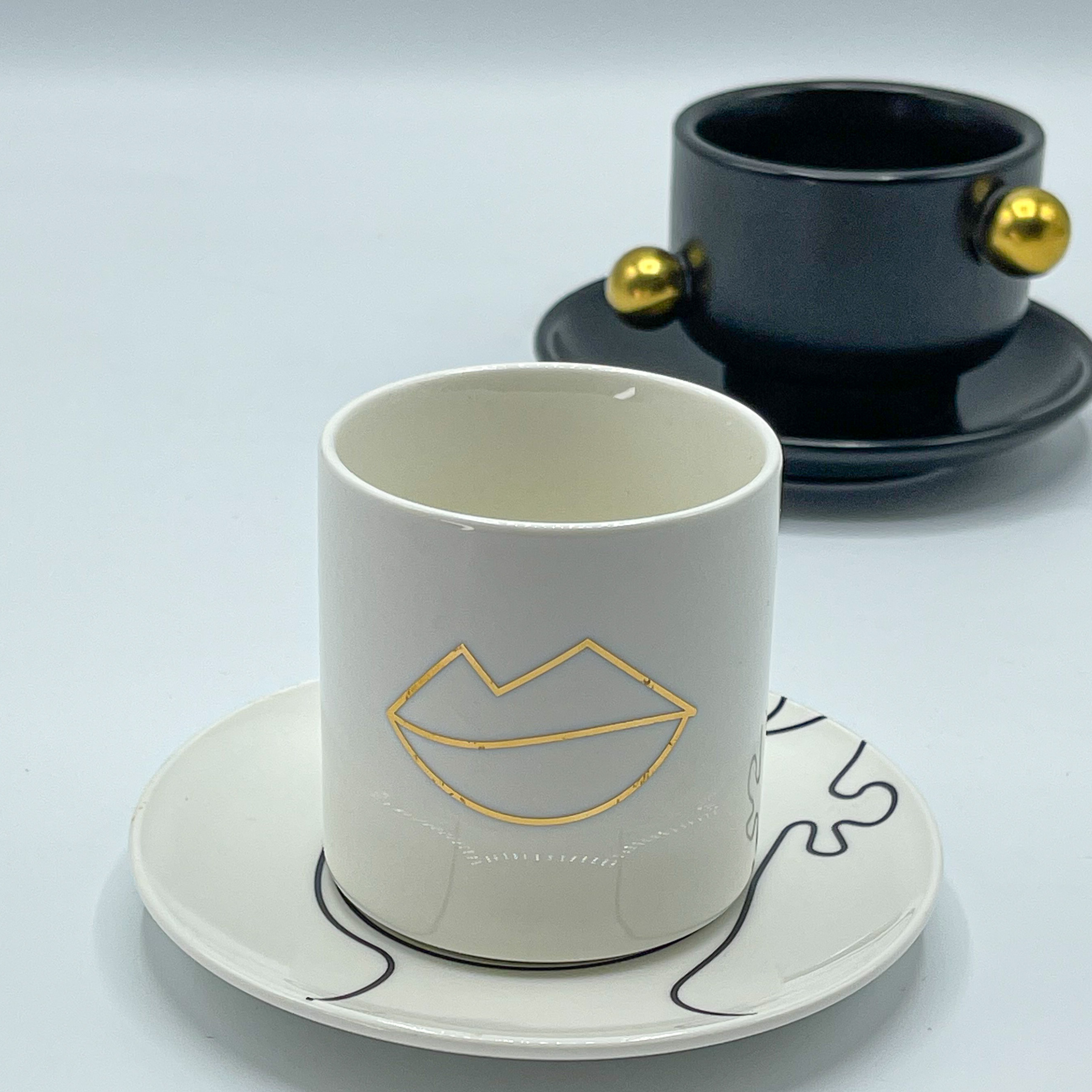 White mouth cup with gold drawing